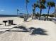 Inviting beach view featuring picnic tables, beachside grill, and views of the bay, perfect for seaside relaxation at 4854 Marine Pkwy # 103, New Port Richey, FL 34652