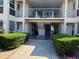 A well maintained two-story condominium with tidy landscaping and a walkway entrance at 4854 Marine Pkwy # 103, New Port Richey, FL 34652