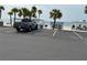 Street view of community parking and beach access in a waterfront community at 4854 Marine Pkwy # 103, New Port Richey, FL 34652