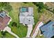 Aerial view of a property with a screened-in pool and meticulously maintained landscaping at 487 Waterloo Ct, Spring Hill, FL 34609