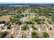Expansive aerial view of a residential community featuring lush landscaping and diverse home styles at 487 Waterloo Ct, Spring Hill, FL 34609