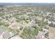 Aerial view of a home nestled in a lush, green neighborhood showcasing its location and surroundings at 487 Waterloo Ct, Spring Hill, FL 34609