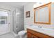 Bright bathroom featuring a glass-enclosed shower, white vanity, and a door to the outside at 487 Waterloo Ct, Spring Hill, FL 34609