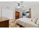 Bedroom features a ceiling fan, closet, and a sliding glass door to the outside at 487 Waterloo Ct, Spring Hill, FL 34609