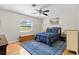 Bedroom featuring wood laminate flooring, ceiling fan, and a large window at 487 Waterloo Ct, Spring Hill, FL 34609