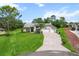 Inviting single-story home featuring a lush lawn and a curved driveway at 487 Waterloo Ct, Spring Hill, FL 34609