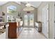 Bright foyer with neutral colors, tiled floors, and a decorative glass front door at 487 Waterloo Ct, Spring Hill, FL 34609