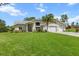 Charming single-story home featuring a well-manicured lawn, two-car garage, and elegant front entrance at 487 Waterloo Ct, Spring Hill, FL 34609