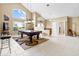 Large game room featuring a billiards table, high ceilings, and ample natural light at 487 Waterloo Ct, Spring Hill, FL 34609