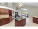 Modern kitchen with granite countertops, stainless steel appliances, and island with breakfast bar at 487 Waterloo Ct, Spring Hill, FL 34609