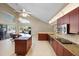 Bright, open kitchen with island, stainless steel appliances, and view to the lanai at 487 Waterloo Ct, Spring Hill, FL 34609