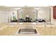 Granite countertops and a stainless steel sink overlook an open living area with fireplace at 487 Waterloo Ct, Spring Hill, FL 34609