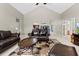 Open living area with view to kitchen, vaulted ceiling, stylish rug and neutral tile floors at 487 Waterloo Ct, Spring Hill, FL 34609