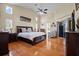 Spacious primary bedroom with high ceilings, a ceiling fan, and hardwood floors throughout at 487 Waterloo Ct, Spring Hill, FL 34609