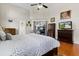 Primary bedroom with ceiling fan, wood floors, and sliding door access to outdoor patio at 487 Waterloo Ct, Spring Hill, FL 34609