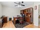Office with hardwood floors, ceiling fan, and large built-in shelving with cabinets at 487 Waterloo Ct, Spring Hill, FL 34609