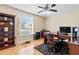 Office with hardwood floors, ceiling fan, built-in shelving, desk, and window at 487 Waterloo Ct, Spring Hill, FL 34609