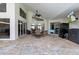 Covered outdoor patio with brick flooring, ceiling fan, and sliding glass doors at 487 Waterloo Ct, Spring Hill, FL 34609