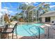 Inviting screened-in pool with water features and a poolside bar area at 487 Waterloo Ct, Spring Hill, FL 34609