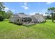 Spacious backyard with a screened-in pool and ample green space at 487 Waterloo Ct, Spring Hill, FL 34609