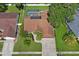 Aerial view of the home showcasing the backyard pool, solar panels, and well-maintained landscaping at 4923 Fort Peck Rd, New Port Richey, FL 34655