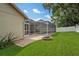 Enjoy this backyard with a screened-in pool, brick-paved patio, and fire pit, perfect for relaxing and entertaining at 4923 Fort Peck Rd, New Port Richey, FL 34655