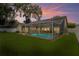 The backyard boasts a screened-in pool, brick-paved patio, and lush lawn perfect for outdoor activities at 4923 Fort Peck Rd, New Port Richey, FL 34655