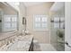 Elegant bathroom featuring granite countertops, modern fixtures, and a glass enclosed shower at 4923 Fort Peck Rd, New Port Richey, FL 34655