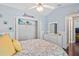 Bedroom featuring decorative pillows, closet, ceiling fan, stylish décor, and wood laminate floors at 4923 Fort Peck Rd, New Port Richey, FL 34655