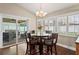 Charming breakfast nook featuring wood floors, large windows with backyard views, and slider doors to the porch at 4923 Fort Peck Rd, New Port Richey, FL 34655