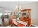 Formal dining room featuring dark wood floors, elegant lighting, and an adjacent kitchen area at 4923 Fort Peck Rd, New Port Richey, FL 34655