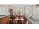 Formal dining room featuring dark wood floors, elegant lighting, and views of the front yard at 4923 Fort Peck Rd, New Port Richey, FL 34655