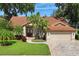Beautiful single-story home with a brick-paved driveway, 2-car garage, and tropical landscaping at 4923 Fort Peck Rd, New Port Richey, FL 34655