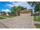 Charming home featuring a paved driveway, well-manicured lawn, and mature trees enhancing curb appeal at 4923 Fort Peck Rd, New Port Richey, FL 34655