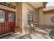 Inviting front porch with a decorative glass door, outdoor seating, and potted flowers creating a welcoming entrance at 4923 Fort Peck Rd, New Port Richey, FL 34655