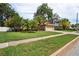 Charming single-story home with a well-manicured lawn, lush landscaping, and mature palm trees at 4923 Fort Peck Rd, New Port Richey, FL 34655