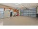 Clean, organized two-car garage with epoxy flooring, storage shelves, and ample space for vehicles and equipment at 4923 Fort Peck Rd, New Port Richey, FL 34655