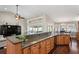 Kitchen with island bar overlooks a dining area and living room at 4923 Fort Peck Rd, New Port Richey, FL 34655