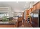 Well-appointed kitchen featuring stainless steel appliances, granite countertops, and custom cabinetry at 4923 Fort Peck Rd, New Port Richey, FL 34655