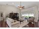 Open-concept living room with soaring ceilings, hardwood floors, lots of natural light and comfortable furnishings at 4923 Fort Peck Rd, New Port Richey, FL 34655