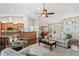 A comfortable living room featuring vaulted ceilings, hardwood floors, neutral paint and lots of natural light at 4923 Fort Peck Rd, New Port Richey, FL 34655