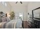 Tranquil main bedroom boasting dark wood floors, modern ceiling fan, and a slider to the lanai at 4923 Fort Peck Rd, New Port Richey, FL 34655