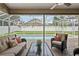 A covered outdoor living space featuring comfortable wicker furniture with views of the refreshing screened-in pool at 4923 Fort Peck Rd, New Port Richey, FL 34655