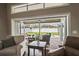 Inviting patio with comfortable seating, ceiling fan, and a clear view of the pool and backyard at 4923 Fort Peck Rd, New Port Richey, FL 34655