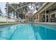 Sparkling screened in swimming pool that provides a serene outdoor experience at 4923 Fort Peck Rd, New Port Richey, FL 34655