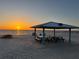 Beach scene with a gazebo and a picnic table at sunset at 5111 Amulet Dr # 102, New Port Richey, FL 34652