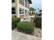 Condo exterior with beige and brown siding, trimmed windows and landscaping at 5111 Amulet Dr # 102, New Port Richey, FL 34652
