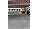 Designated parking area with covered roof and marked parking spots for units 101 and 102 at 5111 Amulet Dr # 102, New Port Richey, FL 34652