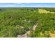 Wide aerial shot of the property set amongst a lush landscape with neighboring pastures in the distance at 5363 Utopia Pl, Brooksville, FL 34601