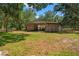 Rustic barn with open stalls surrounded by green grass at 5363 Utopia Pl, Brooksville, FL 34601